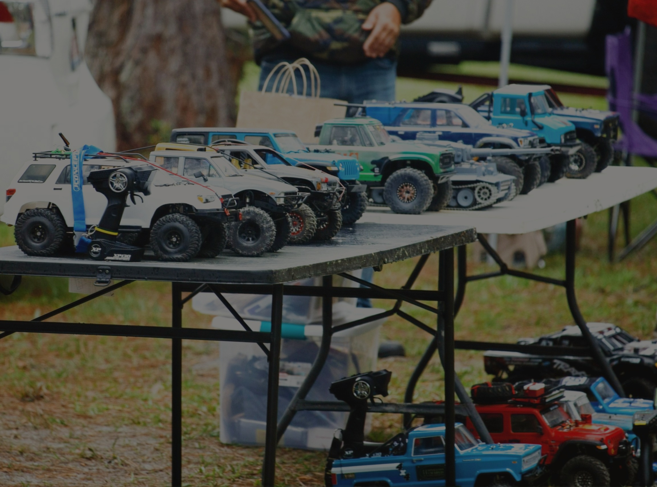 RC rigs lined up on tables at an event