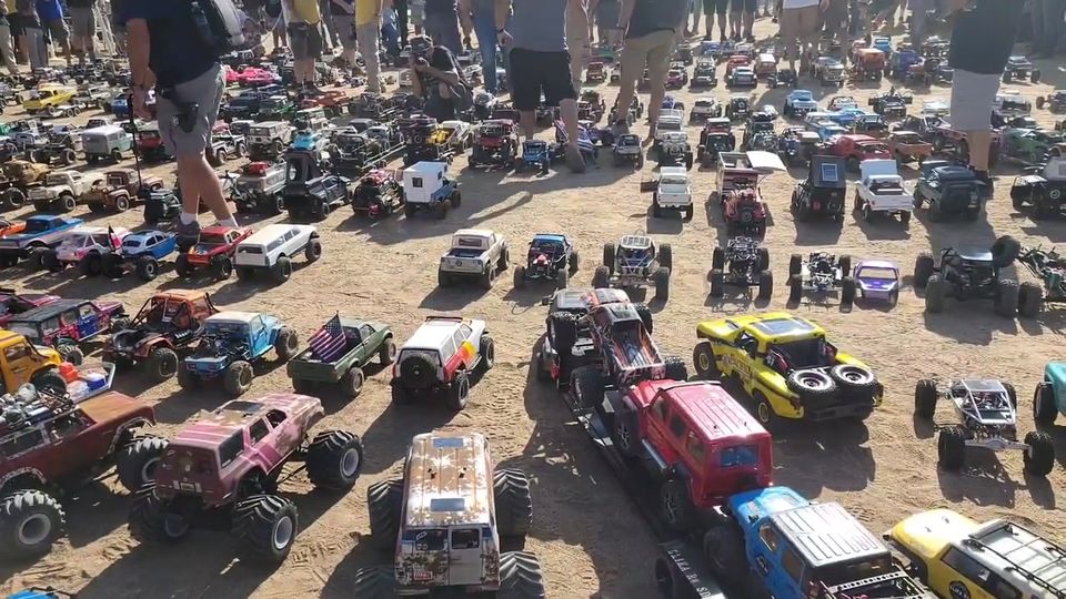 Rows of RC crawlers lined up at a large event