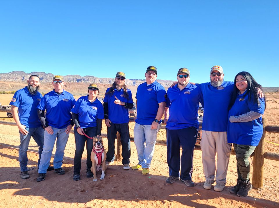 The O11C crew in matching blue shirts in the desert